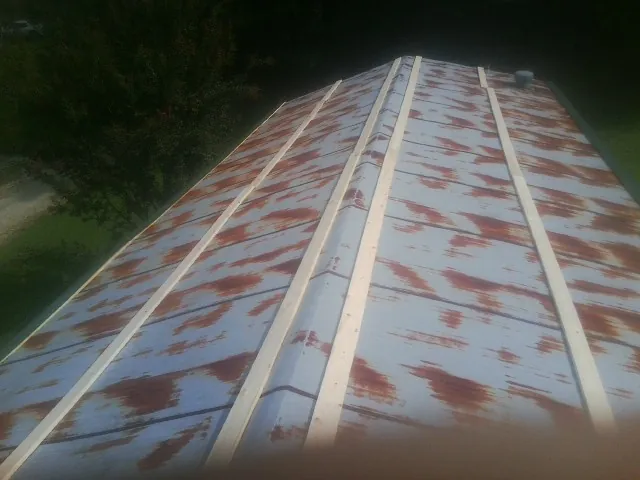 Rusted metal roof panels with new wood purlins before replacement — Storm Damage Roof Repair in Leitchfield by Roofing Brothers