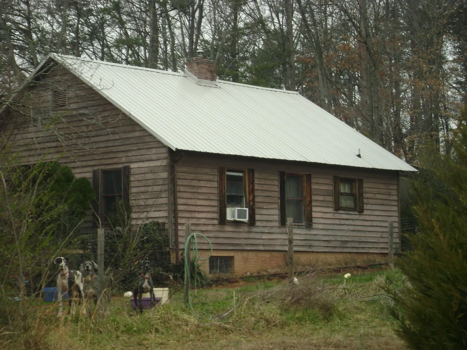 White metal roof on an old wood sided farmhouse, from a Metal Roof Installation job in Leitchfield